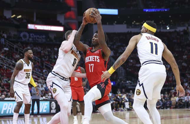 Apr 4, 2023; Houston, Texas, USA; Houston Rockets forward Tari Eason (17) drives with the ball as Denver Nuggets guard Christian Braun (0) defends during the second quarter at Toyota Center.