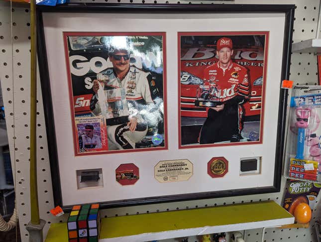 A plaque featuring Dale Earnhardt Jr. and Sr. posing with trophies