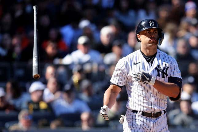 Apr 02, 2023; Bronx, New York, USA; New York Yankees designated hitter Giancarlo Stanton (27) throws his bat after a walk in the seventh inning against the San Francisco Giants at Yankee Stadium.