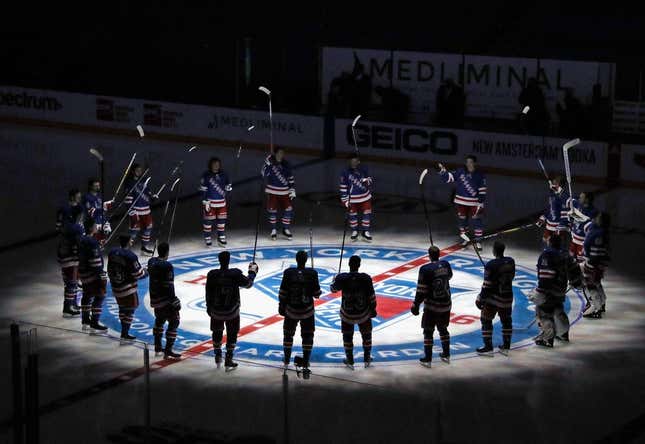 Jan 14, 2021; New York, NY, USA;  New York Rangers players huddle around the center ice logo as they prepare for the home opener against the New York Islanders at Madison Square Garden.