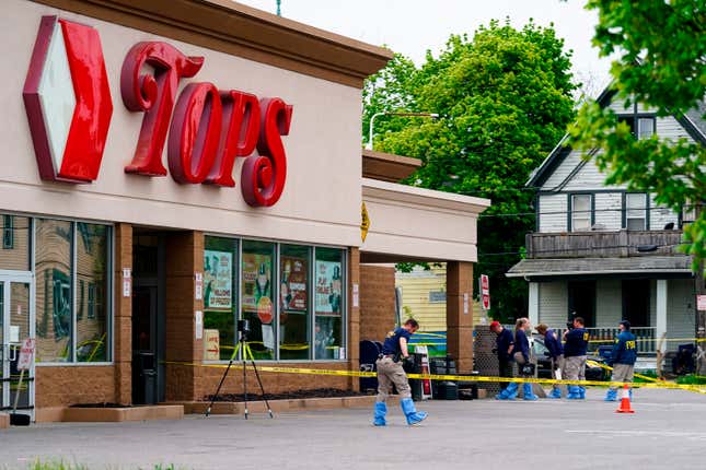Investigators work the scene after a mass shooting at a supermarket, in Buffalo, N.Y., May 16, 2022. A white 18-year-old entered the supermarket with the goal of killing as many Black patrons as possible and gunned down 10.