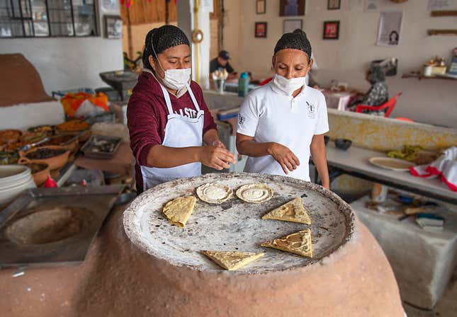 Two cooks prepare maize dishes in Itanoni, a restaurant in the City of Oaxaca that exclusively uses native maize varieties.