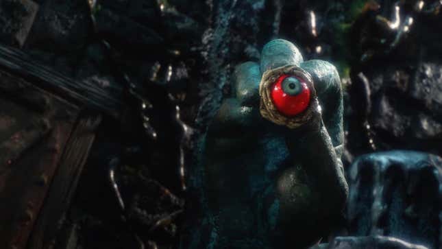 A surreal scene from Phil Tippett's stop-motion film Mad God features a hand holding a red and green eyeball..