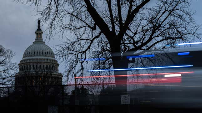 Security fencing surrounds the U.S. Capitol building as a police car drives by on February 7, 2023 in Washington, DC