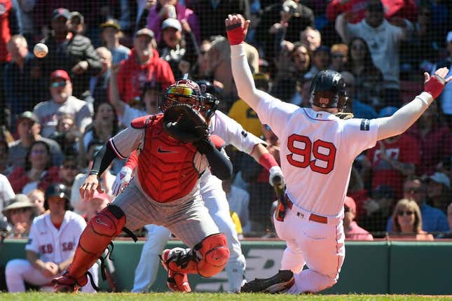 Apr 20, 2023; Boston, Massachusetts, USA; Boston Red Sox right fielder Alex Verdugo (99) slides home against the Minnesota Twins during the third inning at Fenway Park.