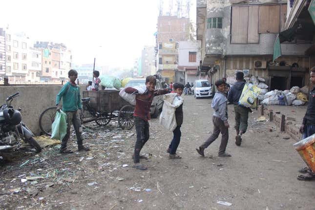 Young boys searching for valuable metal components they can sell in Seelampur.