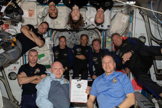 Four civilian astronauts on the Axiom-1 mission, center, join the crew of the International Space Station.