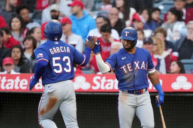 May 6, 2023; Anaheim, California, USA; Texas Rangers right fielder Adolis Garcia (53) celebrates with third baseman Josh Jung (6) after scoring in the fourth inning against the Los Angeles Angels at Angel Stadium.