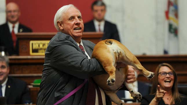 West Virginia Gov. Jim Justice holds up his dog on Jan. 27, 2022, in Charleston.