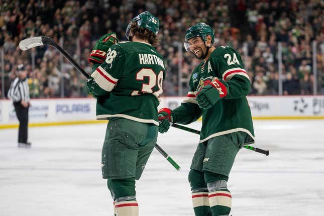 Feb 11, 2023; Saint Paul, Minnesota, USA; Minnesota Wild right wing Ryan Hartman (38) celebrates with defenseman Matt Dumba (24) after tying the game against the New Jersey Devils in the third period at Xcel Energy Center.