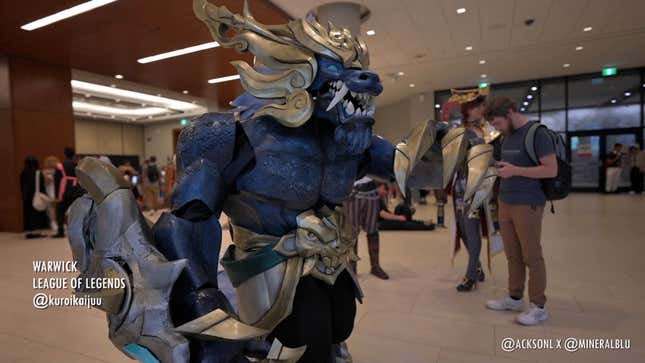 A cosplayer dressed as Warwick from League of Legends stands in the lobby of Fan Expo Canada. 