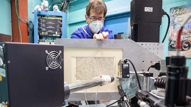 Michael Toth removes a Greek document from the beamline at Stanford Synchrotron Radiation Lightsource.