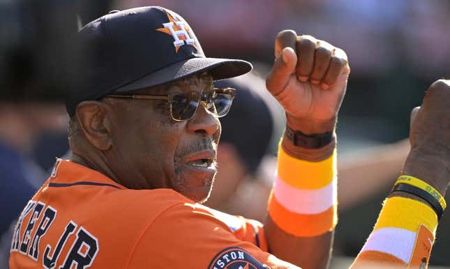 Jul 16, 2023; Anaheim, California, USA;  Houston Astros manager Dusty Baker Jr. (12) gives signs from the dugout in the fifth inning against the Los Angeles Angels at Angel Stadium.