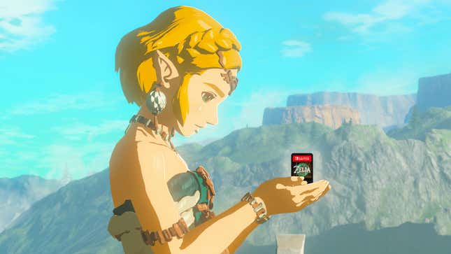 Zelda holds the Tears of the Kingdom cartridge in her hands. 