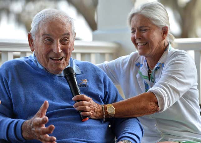 Mary Lujack, right, holds a microphone for her father, Johnny Lujack, winner of the 1947 Heisman Memorial Trophy at The Founder&#39;s Club on Tuesday. Lujack spoke to members on the veranda of the clubhouse after accompanying his daughter and some of her friends on the golf course.

Sar Lujack Heisman 001