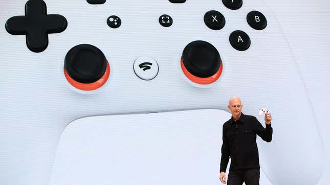 A Stadia exec shows the controller on stage at Google's big showcase. 