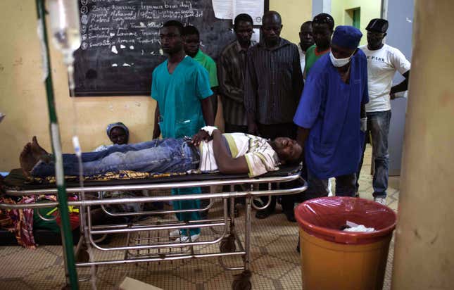 A protestor lays injured on a stretches in hospital in Ouagadougou