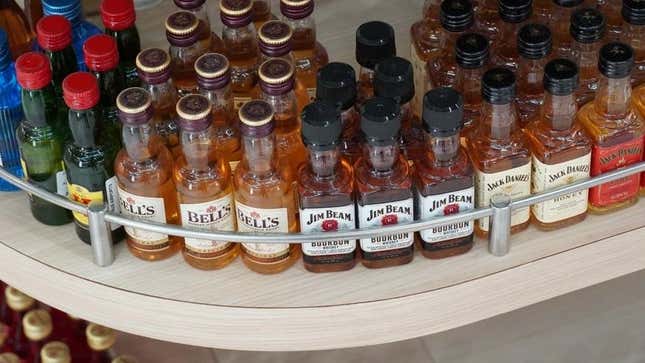 Miniature bottles of whiskey on shelf