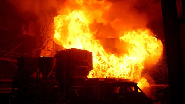 huge fireball erupts as steel scrap is dropped into 3,000-degree Fahrenheit molten steel in a furnace.