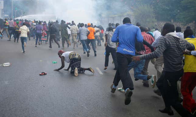 Protesters running from police.