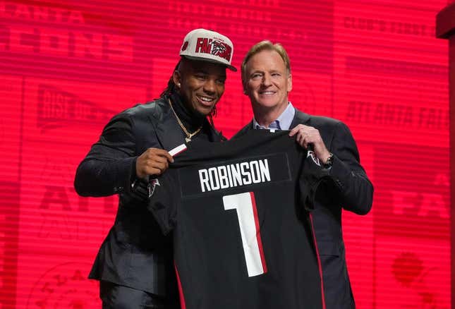 Apr 27, 2023; Kansas City, MO, USA;  Texas running back Bijan Robinson with NFL commissioner Roger Goodell after being selected by the Atlanta Falcons eighth overall in the first round of the 2023 NFL Draft at Union Station.