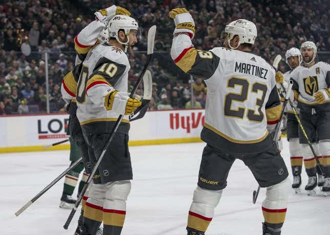 Feb 9, 2023; Saint Paul, Minnesota, USA; Vegas Golden Knights center Nicolas Roy (10) is congratulated by defenseman Alec Martinez (23) and teammates after scoring in the first period against the Minnesota Wild at Xcel Energy Center.