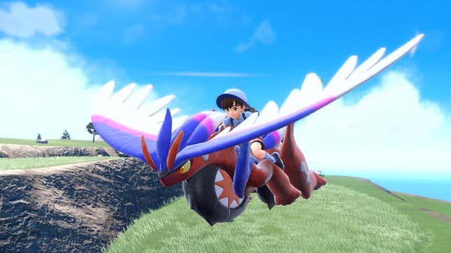 A trainer ride Kiraidon in Pokémon Scarlet.