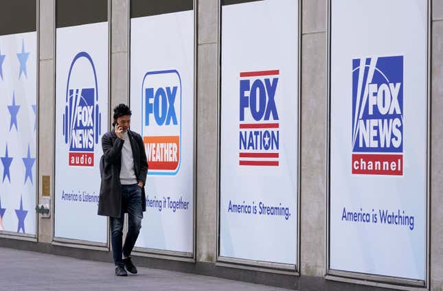 FILE - A person walks past the News Corp. and Fox News headquarters on April 19, 2023, in New York. New York City&#39;s pension funds and the state of Oregon sued Fox Corporation on Tuesday, Sept. 12, alleging the company harmed investors by allowing Fox News to broadcast falsehoods about the 2020 election that exposed the network to defamation lawsuits. (AP Photo/Mary Altaffer, File)