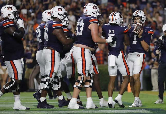 Sep 16, 2023; Auburn, Alabama, USA; Auburn Tigers quarterback Payton Thorne (1) celebrates with teammates after scoring a touchdown against the Samford Bulldogs during the second quarter at Jordan-Hare Stadium.