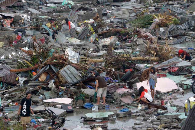 Residents try to salvage belongings in Tacloban city, Leyte province, central Philippines on Sunday, Nov. 10, 2013. The city remains littered with debris from damaged homes as many complain of shortages of food and water and no electricity since Typhoon Haiyan slammed into their province. Haiyan, one of the most powerful storms on record, slammed into six central Philippine islands on Friday, leaving a wide swath of destruction and scores of people dead.
