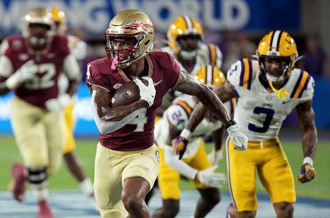 Sep 3, 2023; Orlando, Florida, USA; Florida State Seminoles wide receiver Keon Coleman (4) runs the ball for a touchdown during the first half against the Louisiana State Tigers at Camping World Stadium.