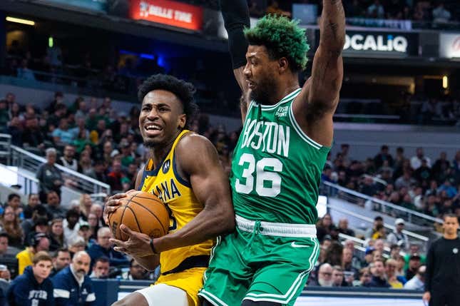 Feb 23, 2023; Indianapolis, Indiana, USA; Indiana Pacers forward Aaron Nesmith (23) shoots the ball while Boston Celtics guard Marcus Smart (36) defends in the first quarter at Gainbridge Fieldhouse.