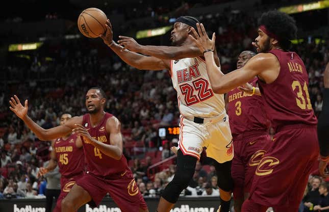 Mar 10, 2023; Miami, Florida, USA;  Miami Heat forward Jimmy Butler (22) passes the ball as Cleveland Cavaliers center Jarrett Allen (31) defends during the first half at Miami-Dade Arena.