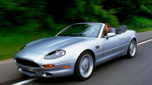 A photo of a 1990s Aston Martin DB7 with the roof down. 
