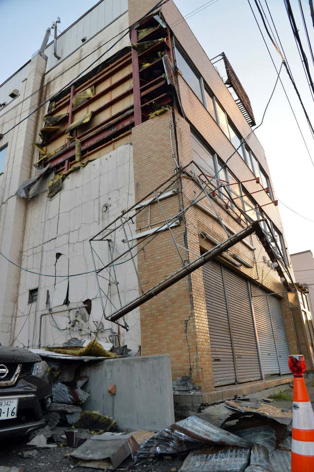 Debris litter the ground next to a damaged building after a strong earthquake hit overnight in Sapporo.