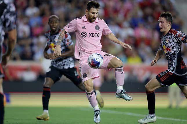 Aug 26, 2023; Harrison, New Jersey, USA; Inter Miami CF forward Lionel Messi (10) controls the ball against New York Red Bulls defender Andres Reyes (4) and midfielder Peter Stroud (5) during the second half at Red Bull Arena.