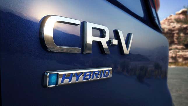 A photo of the logo on a blue Honda CR-V Hybrid SUV.