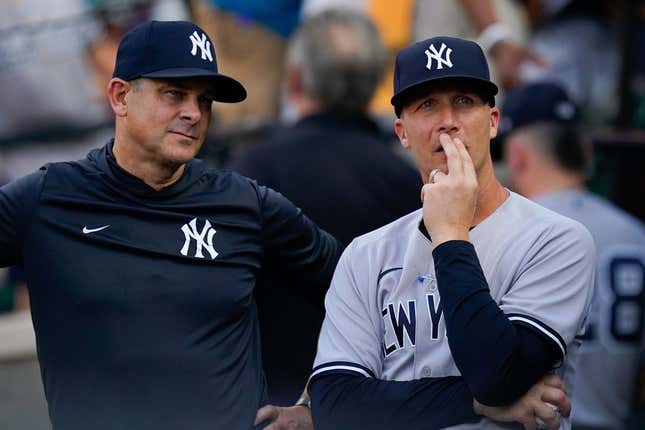 Jul 22, 2022; Baltimore, Maryland, USA; New York Yankees hitting coach Dillon Lawson (74) stands with manager Aaron Boone (17)  before the game against the Baltimore Orioles at Oriole Park at Camden Yards.