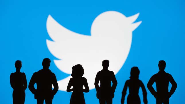 Black silhouettes of people are shown in front of Twitter's white bird logo against a blue background.