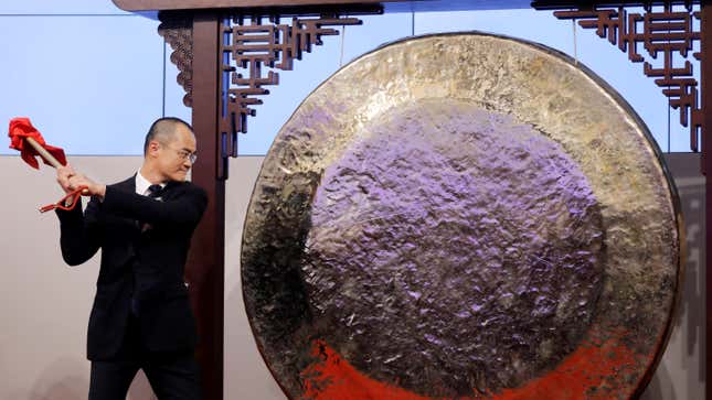 Wang Xing, co-founder, chairman and chief executive officer of China's Meituan Dianping hits the gong during the debut of the company at the Hong Kong Exchanges in Hong Kong, China September 20, 2018.