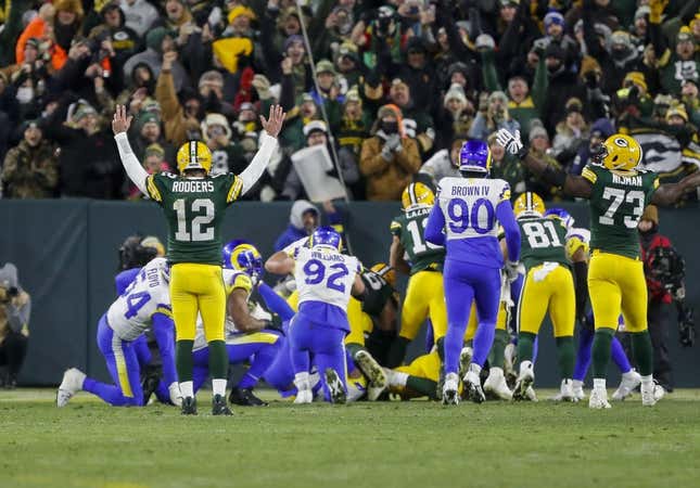 Dec 19, 2022; Green Bay, Wisconsin, USA; Green Bay Packers quarterback Aaron Rodgers (12) reacts as running back AJ Dillon scores a touchdown against the Los Angeles Rams at Lambeau Field.