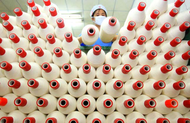 An employee works at a textile factory in Jimo, Shandong province May 19, 2014. China's cabinet has approved detailed plans to be carried out in 2014 to push forward economic reforms, underscoring Beijing's determination to foster more sustainable growth. Picture taken May 19, 2014. REUTERS/China Daily (CHINA - Tags: BUSINESS POLITICS TEXTILE) CHINA OUT. NO COMMERCIAL OR EDITORIAL SALES IN CHINA - GF2EA5K09G801