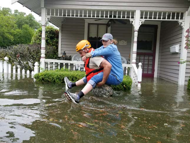 A Texas National Guard soldier carries a woman on his back as they conduct rescue operations in flooded areas around Houston, on Aug. 27.