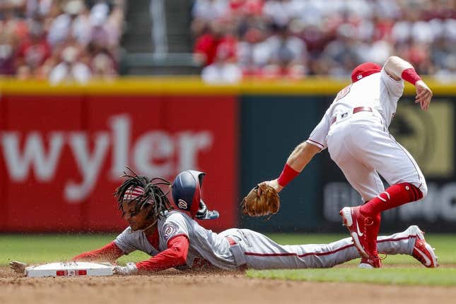 Aug 6, 2023; Cincinnati, Ohio, USA; Cincinnati Reds second baseman Matt McLain (9) attempts to tag out Washington Nationals shortstop CJ Abrams (5) at second in the second inning at Great American Ball Park.