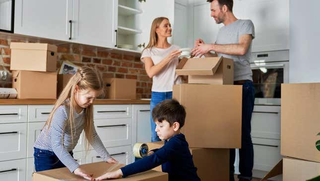 Family packing up boxes in a kitchen