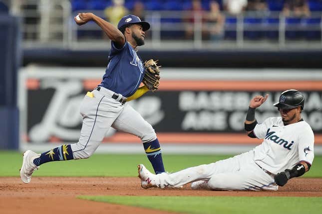 Aug 30, 2023; Miami, Florida, USA; Tampa Bay Rays shortstop Osleivis Basabe (37) completes a double play as Miami Marlins second baseman Luis Arraez (3) slides into second base in the first inning at loanDepot Park.
