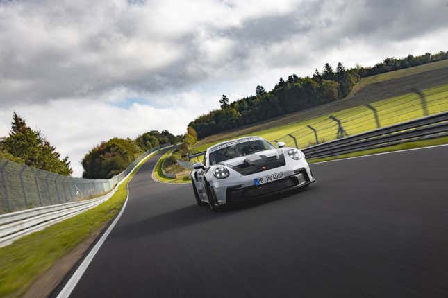 A silver Porsche GT3 RS drives on the Nurburgring.