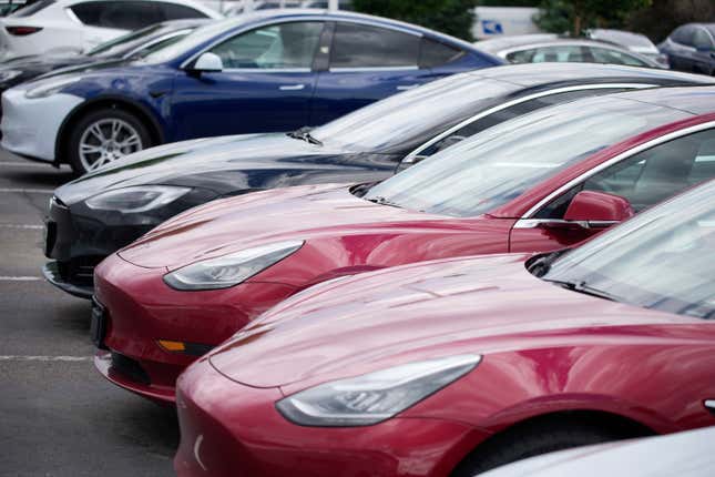 In this Sunday, June 27, 2021, photograph, a handful of unsold 2021 Model 3 sedans sits in a near-empty lot at a Tesla dealership in Littleton, Colo. The company faces a new lawsuit alleging mistreatment of a Black woman at one of its plants.
