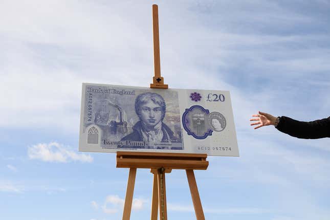 A large scale sample of the new twenty pound note is seen during the launch event for the new note design at the Turner Contemporary gallery on October 10, 2019 in Margate, England.  A hand is reaching towards it.