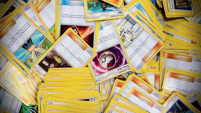 Pokemon cards lay in a pile. 